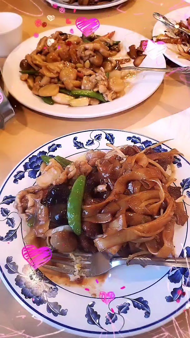 Chinese dishes served on simple white plates.